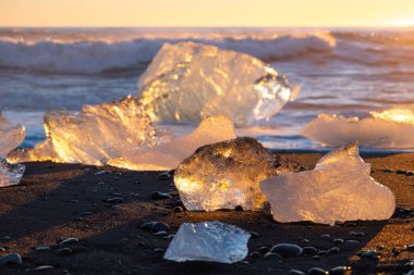 Diamond Beach in Iceland. Icebergs Shining on Black Volcanic Sand at Sunset. Clear Ice Crashed by Ocean Waves. Famous Tourist Location in North Europe Country. Travel Destination. High Resolution.