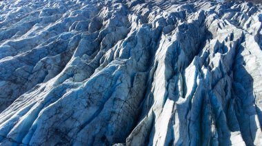 Huge glacier with pure blue ice at sunny weather. Vatnajokull glacier in Iceland. Beautiful nature abstract background. Ice texture landscape aerial view