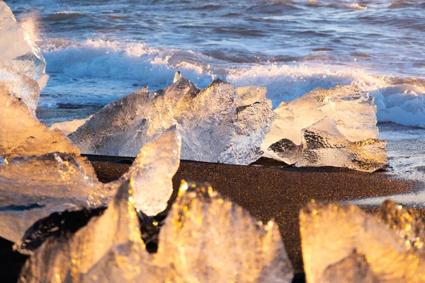 Diamond Beach in Iceland. Icebergs Shining on Black Volcanic Sand at Sunset. Clear Ice Crashed by Ocean Waves. Famous Tourist Location in North Europe Country. Travel Destination. High Resolution.
