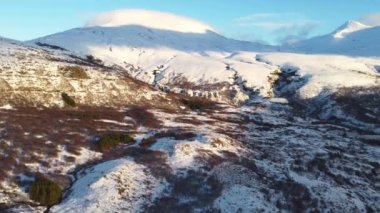 Aerial View Winter Mountain Snow Frozen Morning Landscape White Nature Peaks Cliffs Iceland Cold Top Ice Tourism Eco Travel Mountain Range Golden Hour. High quality 4k footage