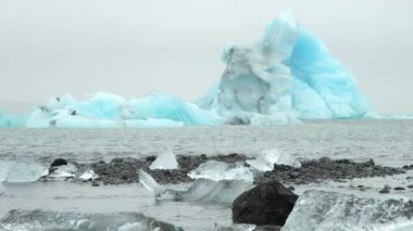 Blue Iceberg in Foggy Glacier Lagoon, Pure Nature in Iceland. Beautiful Natural Miracle in North Country. Ancient Blue Ice Is Melting Due To Global Warming. Winter and Ice Concept. Shot in 8k.