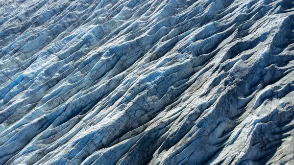Huge glacier with pure blue ice at sunny weather. Vatnajokull glacier covered snow in Iceland. Beautiful nature abstract background. Ice texture landscape aerial view. High quality photo