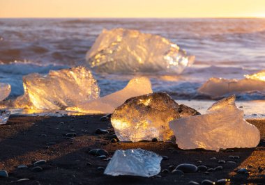 Diamond Beach in Iceland. Icebergs Shining on Black Volcanic Sand at Sunset. Clear Ice Crashed by Ocean Waves. Famous Tourist Location in North Europe Country. Travel Destination. High Resolution