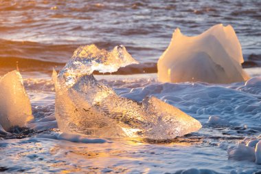 Diamond Beach in Iceland. Icebergs Shining on Black Volcanic Sand at Sunset. Clear Ice Crashed by Ocean Waves. Famous Tourist Location in North Europe Country. Travel Destination. High Resolution