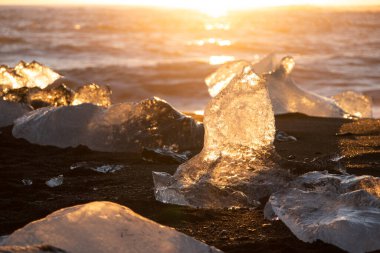 Diamond Beach in Iceland. Icebergs Shining on Black Volcanic Sand at Sunset. Clear Ice Crashed by Ocean Waves. Famous Tourist Location in North Europe Country. Travel Destination. High Resolution
