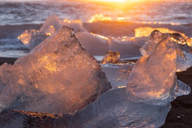 Diamond Beach in Iceland. Icebergs Shining on Black Volcanic Sand at Sunset. Clear Ice Crashed by Ocean Waves. Famous Tourist Location in North Europe Country. Travel Destination. High Resolution.