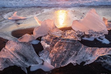 Diamond Beach in Iceland. Icebergs Shining on Black Volcanic Sand at Sunset. Clear Ice Crashed by Ocean Waves. Famous Tourist Location in North Europe Country. Travel Destination. High Resolution.