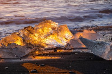 Diamond Beach in Iceland. Icebergs Shining on Black Volcanic Sand at Sunset. Clear Ice Crashed by Ocean Waves. Famous Tourist Location in North Europe Country. Travel Destination. High Resolution.