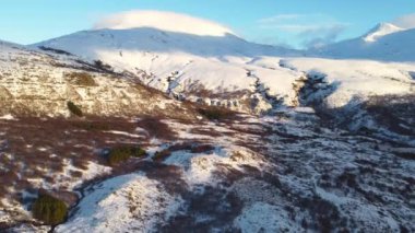 Aerial View Winter Mountain Snow Frozen Morning Landscape White Nature Peaks Cliffs Iceland Cold Top Ice Tourism Eco Travel Mountain Range Golden Hour. High quality 4k footage