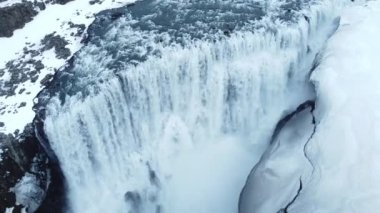 Şelale. İzlanda 'daki büyük dağ nehrinin kıyısında uçuyor. Kış manzarası destansı hava uçuşları. Dettifoss şelalesi ünlü turist beldesi. Saf mavi su ve beyaz kar. Yüksek kalite 4k