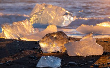 Diamond Beach in Iceland. Icebergs Shining on Black Volcanic Sand at Sunset. Clear Ice Crashed by Ocean Waves. Famous Tourist Location in North Europe Country. Travel Destination. High Resolution.