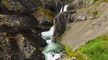 Berrak Dağ Kanyonu 'ndaki Büyük Şelale Temiz İzlanda Bölgesi Güneşli bir Yaz Günü Güzel Turist Çekimi Açık Dağ Buzul Nehri Epic Aerial View 4k. Yüksek kalite 4k görüntü