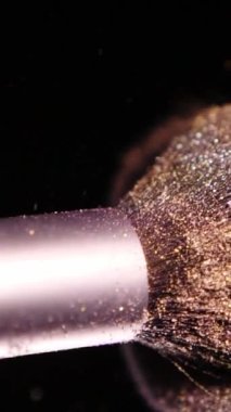 Vertical Screen: Makeup Brushes Touch Each Other on Dark Background and Small Particles of Cosmetics, Beauty Concept Super Slow Motion Content Shot for Social Media. High quality footage