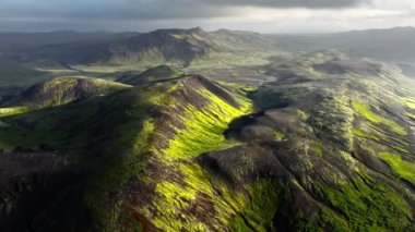 İzlanda dağlarında yosunlarla kaplı güzel siyah volkanik dağlar, sıra dışı doğa manzarası, muhteşem kuşların bakış açısı, insansız hava aracının destansı görüntüsü. 4k