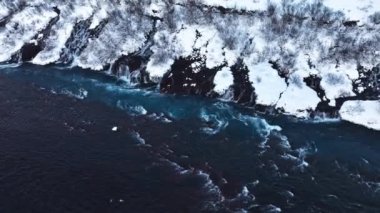 Saf turkuaz su, dev bir akıntısı olan buzul nehri İzlanda 'da şelale, kışın donmuş şelale, kar ve buzun büyülü kış mekanı, popüler turizm merkezi.