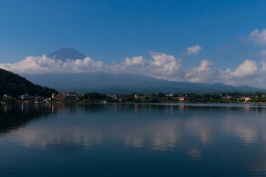 Fuji Dağı 'nın güzel görüntüsü Kawaguchi Gölü' nü vurdu. Su çok yansıtıcıdır. Dağda süzülen bulutlar bunu sihirli bir görüntü gibi gösteriyor. Bu Fujiyoshida Japonya 'da çekildi..