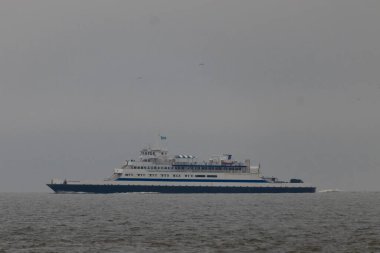 Bu Cape May Lewes perisinin körfez boyunca seyahat edişinin bir görüntüsü. Bu görüntü Cape May New Jersey 'deki Sunset Sahili' nden. Büyük gemi sakin suyun üzerinden sessizce geçiyor..