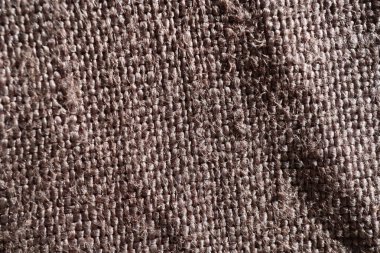 Doğal kumaş ya da kumaş dokusu. Kumaş dokusu, doğal pamuk ya da keten kumaştan çapraz dokuma. Kahverengi branda arka plan. Perde, mobilya, duvar ve kıyafetler için dekoratif kumaş. 