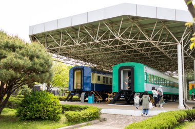 Uiwang City, Gyeonggi Province - 04.23.2023 : Two trains are parked under a roof at Korail Railroad Museum. Travel destination. clipart