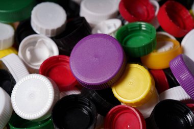 Bir sürü renkli plastik şişe kapağı. Plastik geri dönüşüm. Mor şişe kapağı.