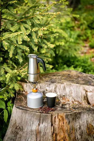 stock image Device for making coffee - a moka pot on a gas burner.