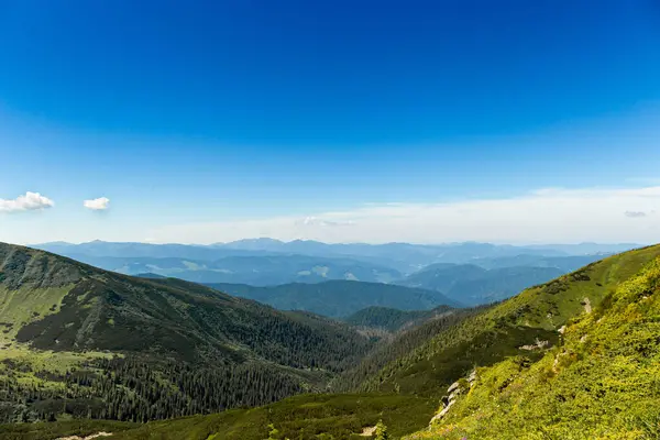 stock image The most beautiful landscape with peaks in the background, sky with clouds on a sunny day.