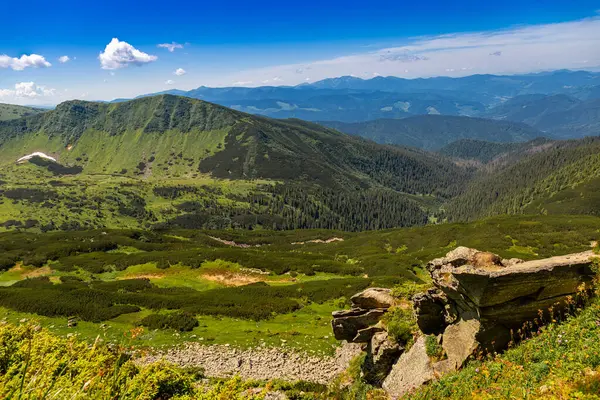 stock image The most beautiful landscape with peaks in the background, sky with clouds on a sunny day.