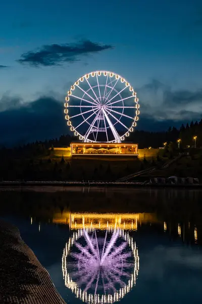 stock image Ferris wheel with beautiful illumination at night. Night landscape attraction in Bukovel.