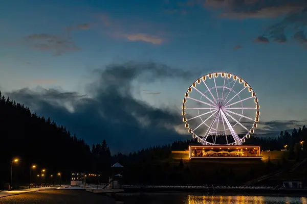 stock image Ferris wheel with beautiful illumination at night. Night landscape attraction in Bukovel.