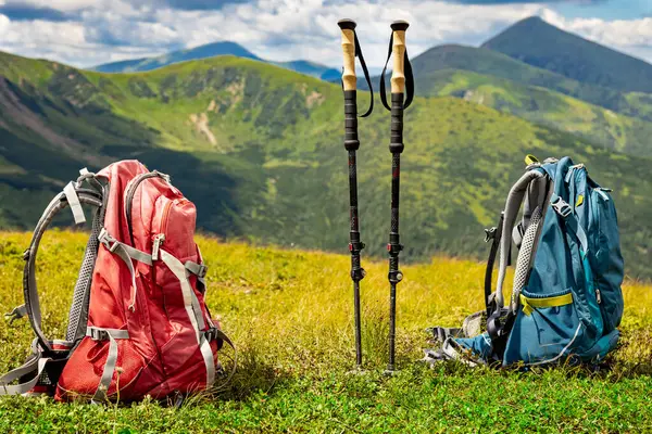 stock image Hiking in the mountains with two backpacks in the summer.