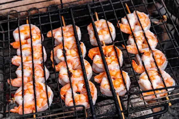 stock image Cooking shrimp over an open fire at a campsite in the summer.