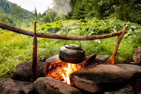 stock image Coffee pot on a campfire during a hike in the mountains.