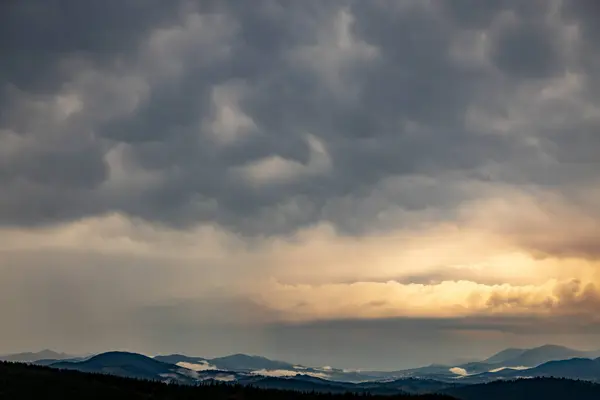 stock image The most beautiful landscape with peaks in the background, sky with clouds at sunset.