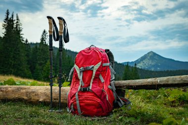 Hike high in the mountains with a backpack, mountain scenery. clipart