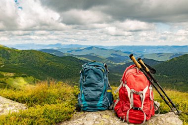 Zirveli ve sırt çantalı dağ manzarası.