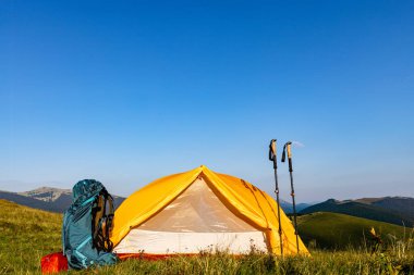 Yazın bir sırt çantası ve çadırla dağlarda yürüyüş yapmak. Dağların güzel manzarası.