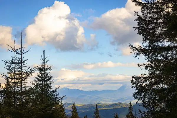 Dağların en güzel manzarası, güneşli bir günde bulutlu gökyüzü..