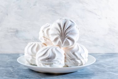 White marshmallow meringue in a plate on the table