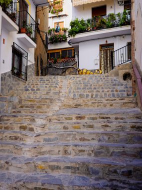 Staircase with a broom at the top in Soportjar, a Spanish town and municipality located in the northwestern part of the Alpujarra Granadina region, in the province of Granada, autonomous community of Andalusia