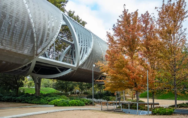 stock image Metal tube-shaped bridge with orange trees around