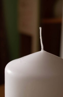 Unlit candle wick standing on a smooth white candle surface. The quiet anticipation of an untouched candle, ready to be lit. Stillness captured: the tranquil wick of a new candle awaits ignition. A candle's wick stands poised. clipart
