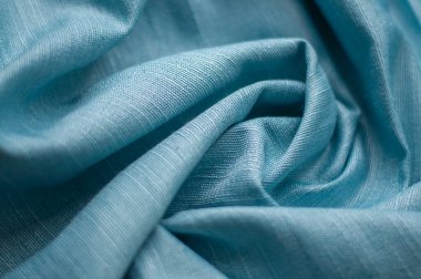 Mavi desenli kumaş katları. Kumaşın mavi arka planı. Perdeler ve ev dekorasyonu için kumaş.