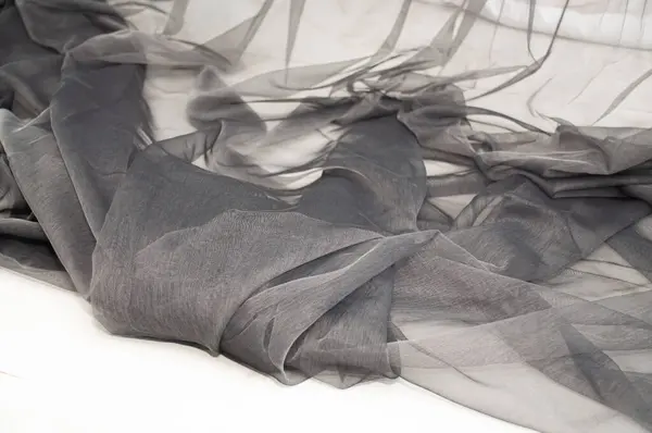 stock image Black tulle with curtain tape and hooks. Black tulle close-up on a white background. Folds on black tulle.