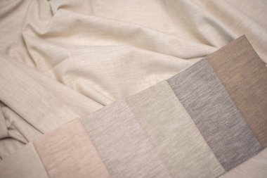 Ev yapımı tekstil ve perdeler için süt, bej ve gri renkli kumaş. Perdeler için kumaş örnekleri.