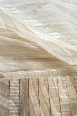 Samples of thin linen tulle striped in beige colors. Samples of linen fabric with shadows and light places. Light and transparent fabric for curtains. clipart