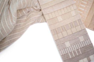 A palette of linen fabric with different stripes in beige tones. Fabric for curtains and tulles. Fabric on a white background. clipart