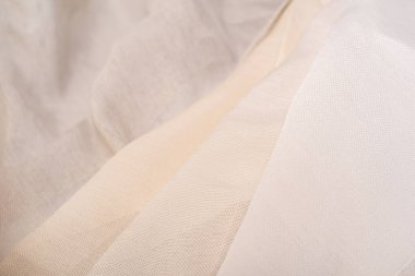 Tül için süt ve bej kumaş örnekleri. Perdeler için açık ve şeffaf kumaş.