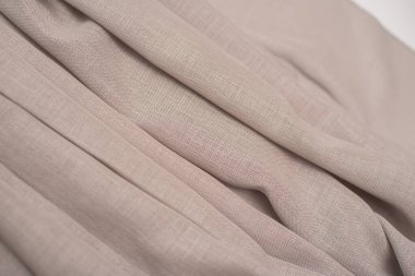 Perdeler için bej kumaş kıvrımlı arka plan. Perdeler için desenli kumaş.