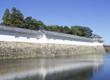 The stone walls, moats and white towers of the Hikone castle  at Shiga Prefecture Japan. clipart