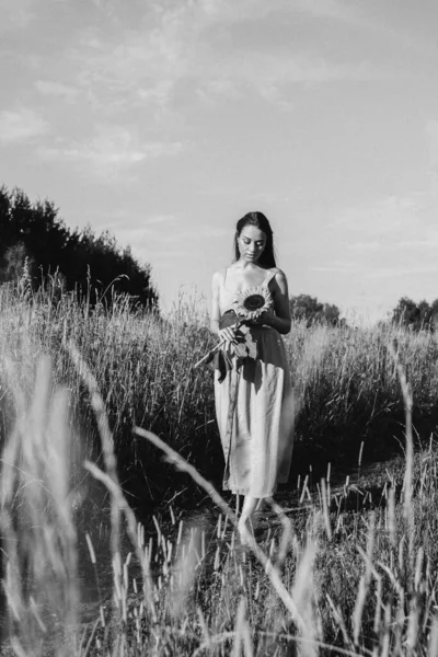 portrait of beautiful young girl in white dress on the meadow